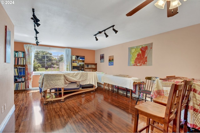 bedroom with hardwood / wood-style flooring and rail lighting