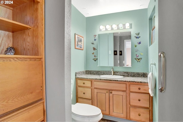 bathroom featuring vanity and toilet