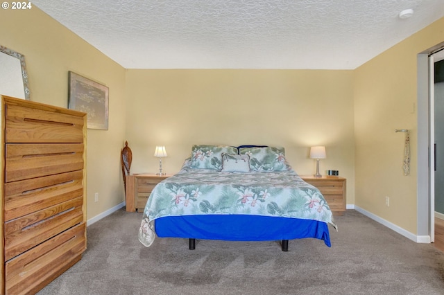 carpeted bedroom featuring a textured ceiling