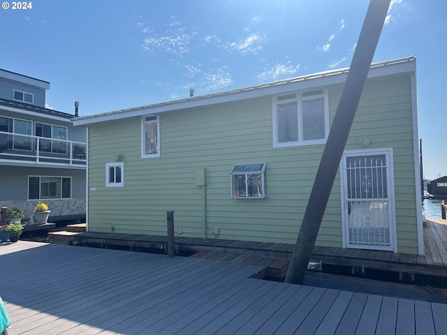 rear view of house with a wooden deck