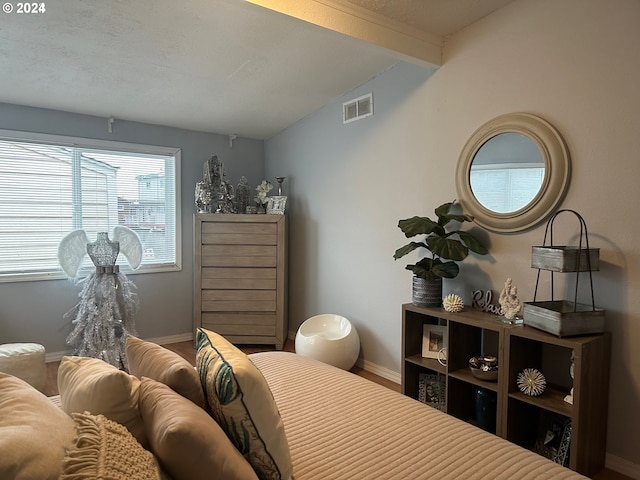 bedroom with lofted ceiling with beams