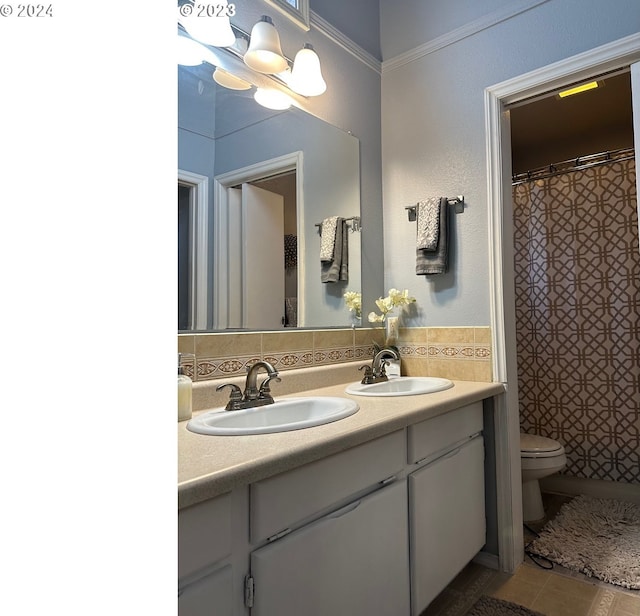 bathroom with tasteful backsplash, vanity, tile patterned floors, and toilet