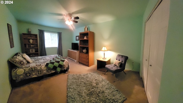bedroom with carpet, ceiling fan, and a closet