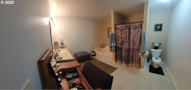 bathroom featuring toilet, curtained shower, a sink, and baseboards