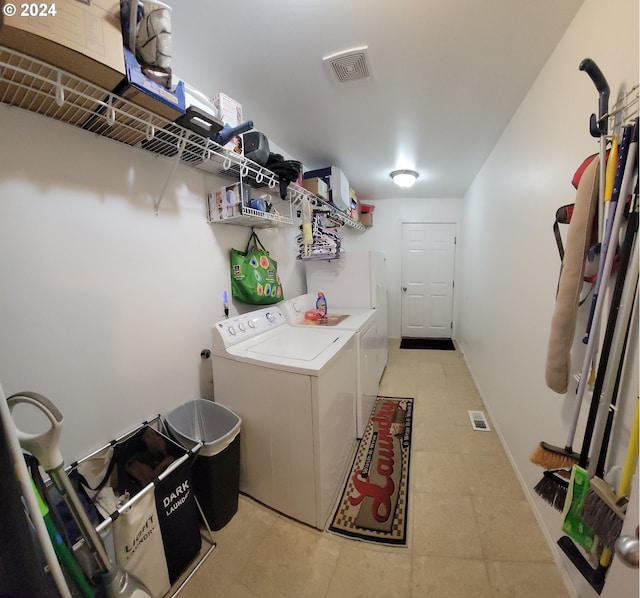 clothes washing area with washer and clothes dryer