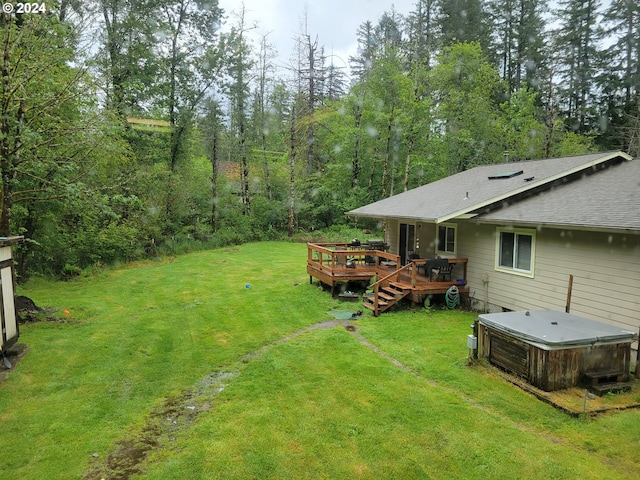 view of yard with a hot tub and a deck