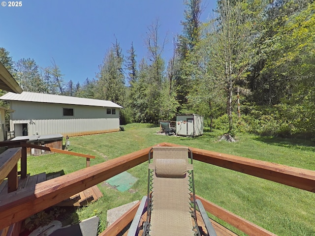 deck featuring a lawn, an outbuilding, and a storage shed