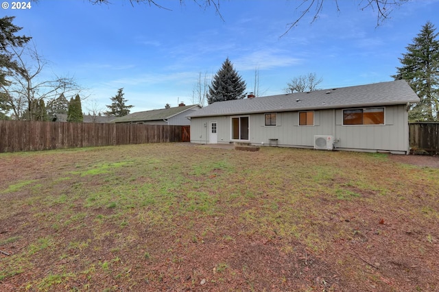 back of house with a yard and ac unit