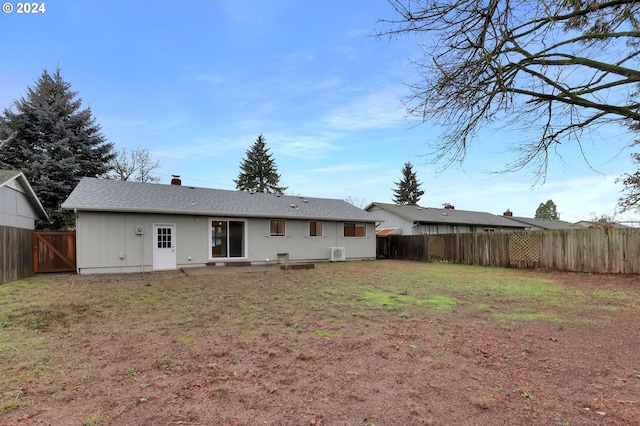 rear view of house with a yard and a patio area