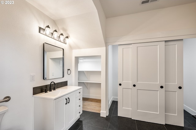 bathroom featuring tile patterned flooring and vanity