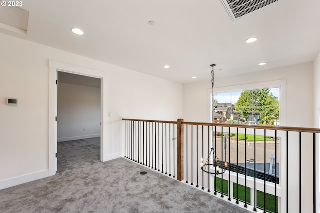 hallway with light colored carpet