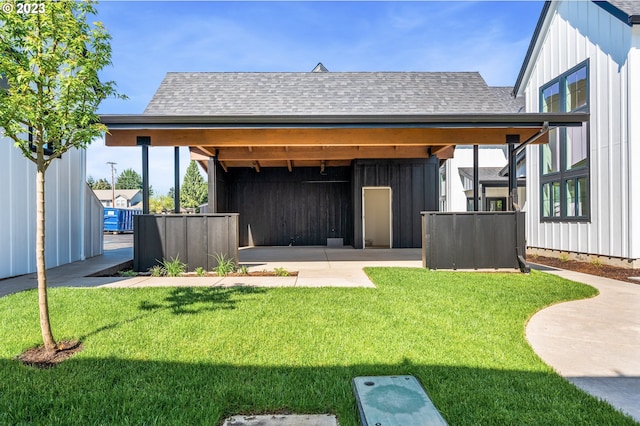 rear view of property featuring a lawn