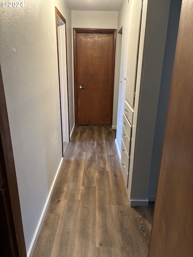 46791 Winfrey Rd, Westfir, OR 97492 - hallway with dark wood-style flooring, baseboards, and a textured wall