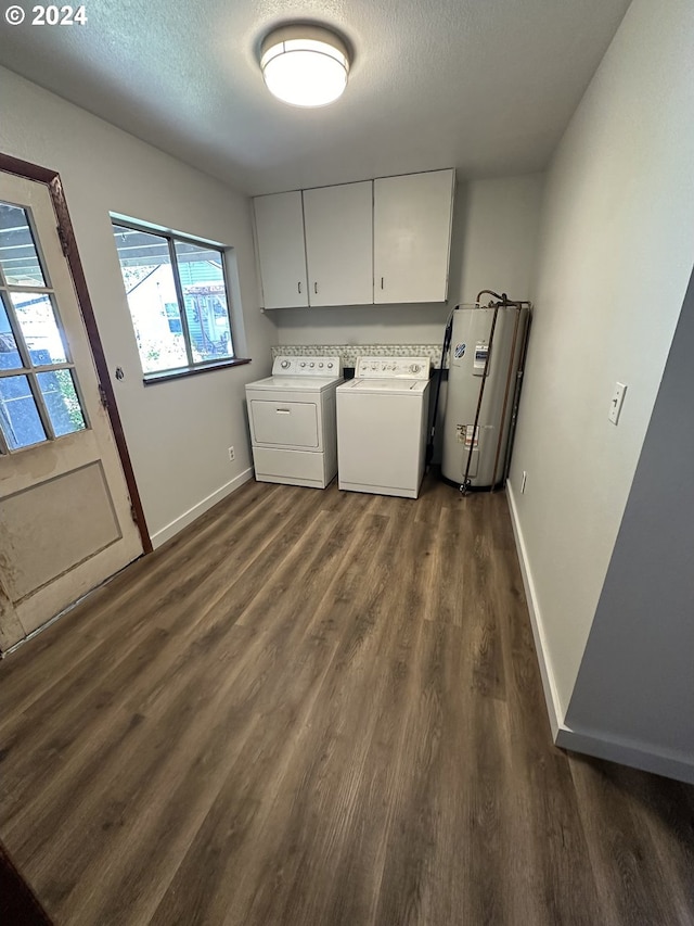 46791 Winfrey Rd, Westfir, OR 97492 - washroom featuring washer and clothes dryer, water heater, dark wood-style flooring, cabinet space, and baseboards