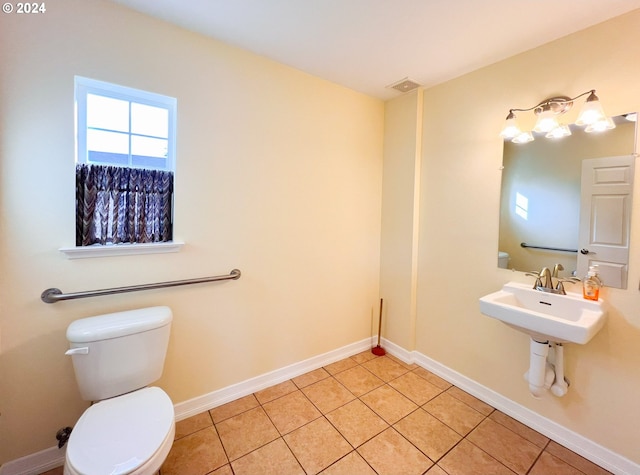 bathroom with tile patterned flooring and toilet