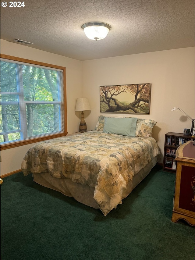 carpeted bedroom with a textured ceiling