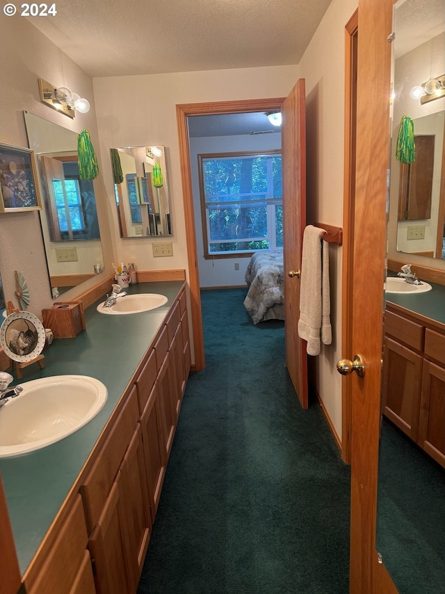 bathroom with vanity and a textured ceiling