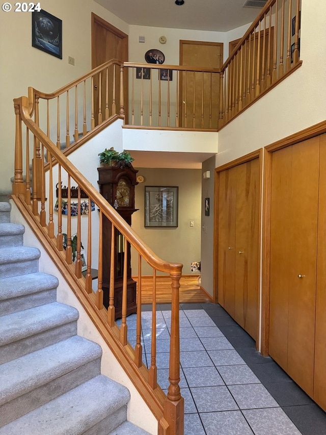 staircase with a high ceiling