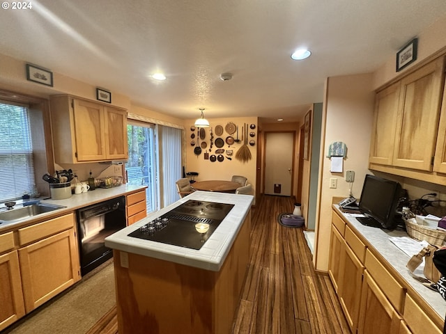 kitchen with light brown cabinets, tile countertops, black appliances, dark wood-type flooring, and a center island