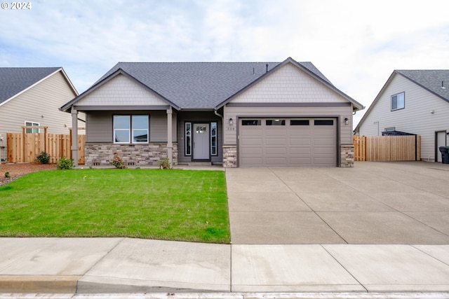 craftsman-style home featuring a garage and a front yard