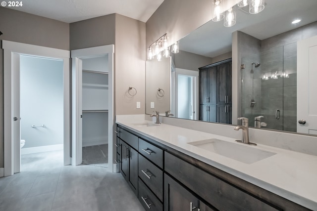 bathroom with vanity, toilet, and an enclosed shower