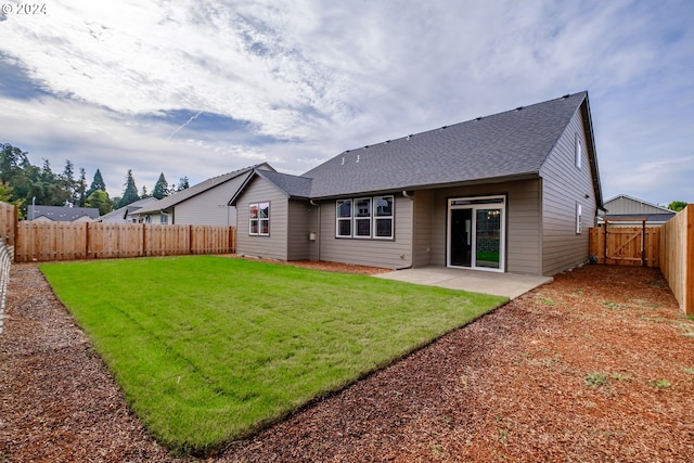 back of property featuring a patio area and a lawn