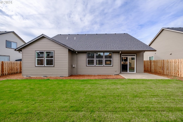 back of house featuring a patio and a yard