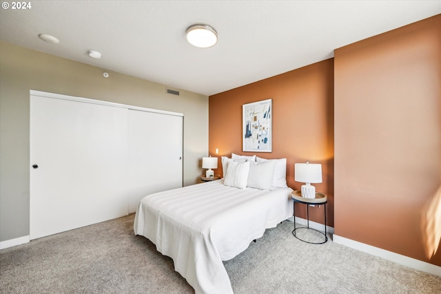 carpeted bedroom featuring a closet