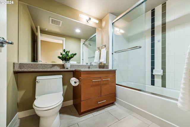 full bathroom with combined bath / shower with glass door, vanity, toilet, and tile patterned floors