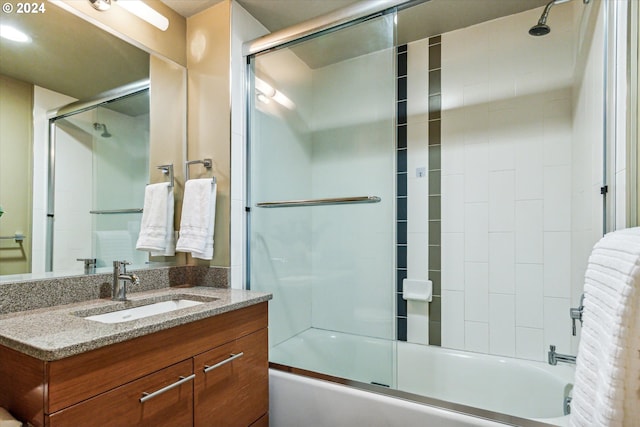 bathroom with shower / bath combination with glass door and vanity