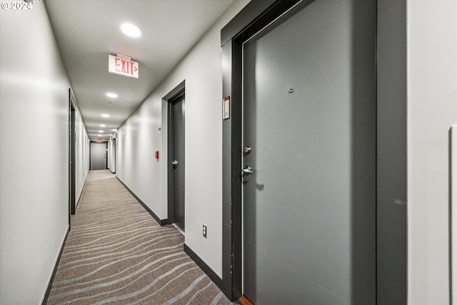 hallway featuring light carpet