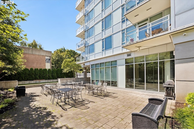 view of patio with a balcony and a grill