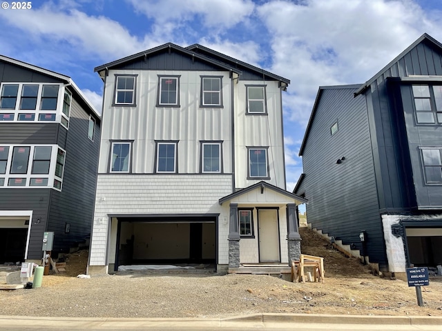 view of front facade with an attached garage, board and batten siding, and driveway