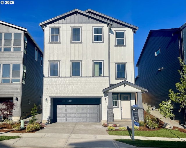 15044 SW 164th Ave Unit L17, Tigard, OR 97224 - view of front facade with board and batten siding, concrete driveway, an attached garage, and brick siding