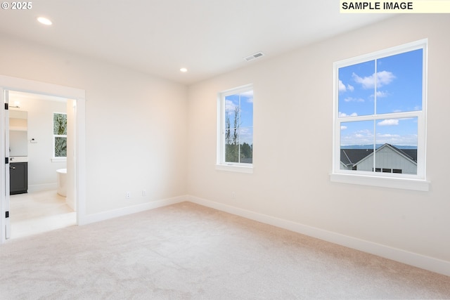 unfurnished bedroom with visible vents, recessed lighting, multiple windows, and carpet floors