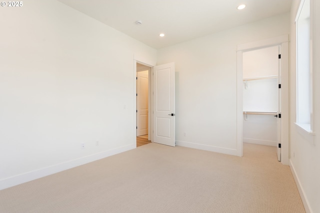 15044 SW 164th Ave Unit L17, Tigard, OR 97224 - unfurnished bedroom with light colored carpet, recessed lighting, a walk in closet, and a closet