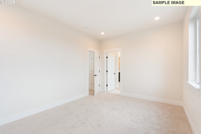 unfurnished room featuring recessed lighting, baseboards, and light carpet