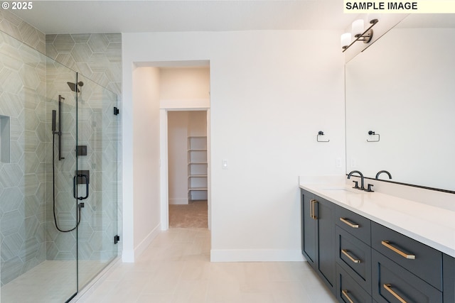 bathroom featuring vanity, baseboards, a stall shower, and tile patterned flooring