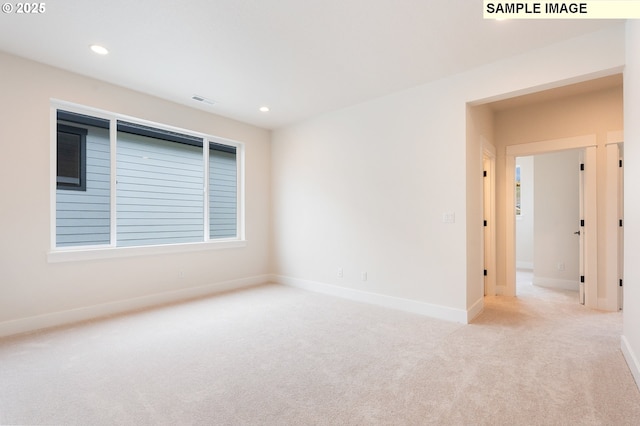 carpeted empty room with visible vents, recessed lighting, and baseboards