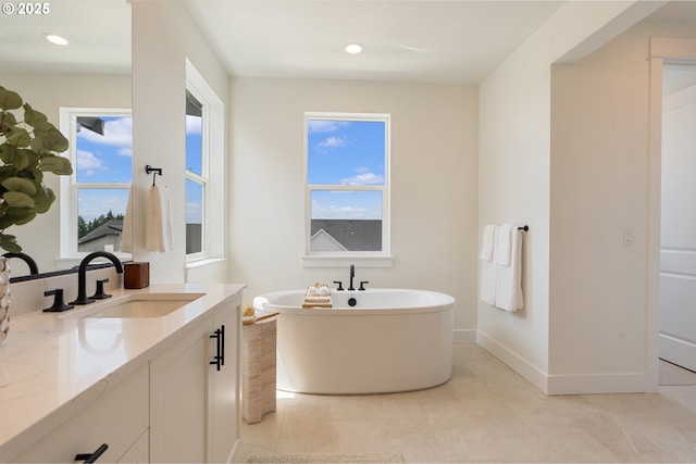 15044 SW 164th Ave Unit L17, Tigard, OR 97224 - bathroom with vanity, a freestanding bath, healthy amount of natural light, tile patterned flooring, and recessed lighting