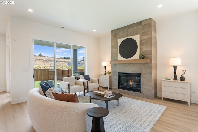 15044 SW 164th Ave Unit L17, Tigard, OR 97224 - living area featuring light wood-style floors, a tiled fireplace, and recessed lighting