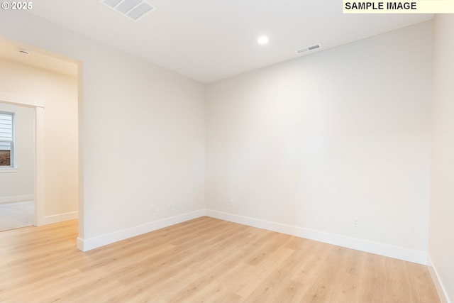 unfurnished room with recessed lighting, visible vents, baseboards, and light wood-style flooring