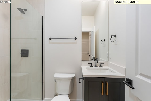 bathroom with a tile shower, toilet, and vanity