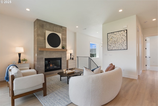 15044 SW 164th Ave Unit L17, Tigard, OR 97224 - living area featuring light wood-style flooring, a tiled fireplace, and recessed lighting