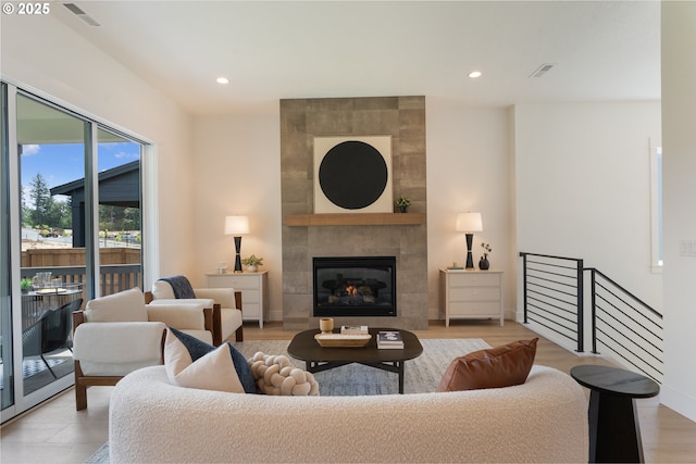 15044 SW 164th Ave Unit L17, Tigard, OR 97224 - living room featuring a fireplace, recessed lighting, and light wood-type flooring