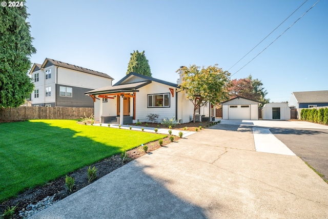 view of front of property featuring an outdoor structure, a garage, and a front lawn