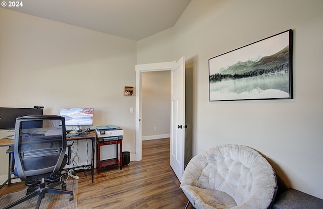 office space with lofted ceiling and dark wood-type flooring