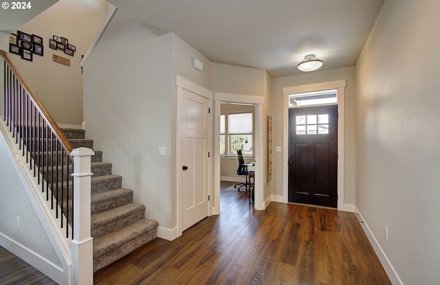 foyer entrance with dark hardwood / wood-style floors