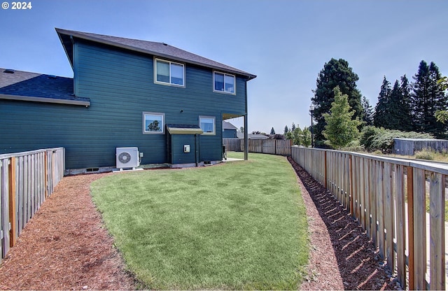 rear view of house with a lawn and ac unit