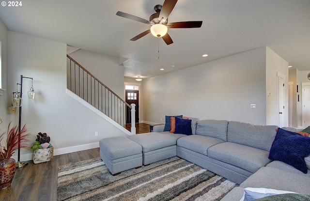 living room with dark wood-type flooring and ceiling fan